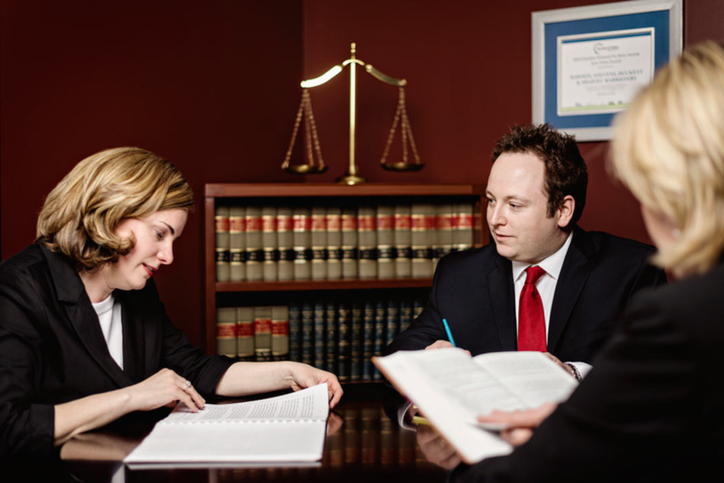Criminal defence lawyers researching with legal texts