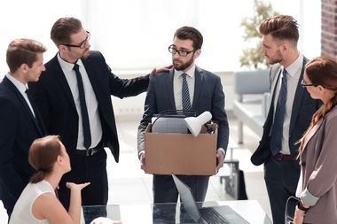 Co-worker consoling fired employee