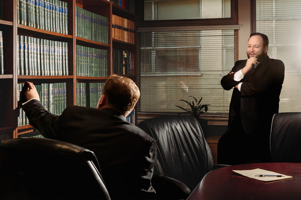 Lawyers having a discussion in a legal library.